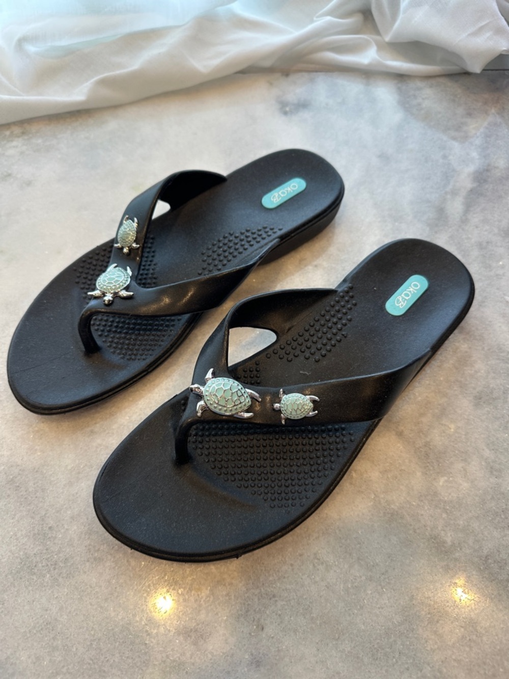 OKA b. Black Flip Flops with Mint Turtle Embellishments
